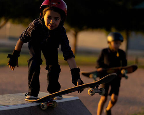 Kids skateboarding on a quarter pipe