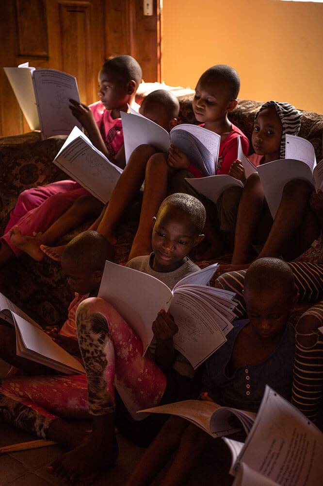 Young African reading Conchita by Donate for Skate