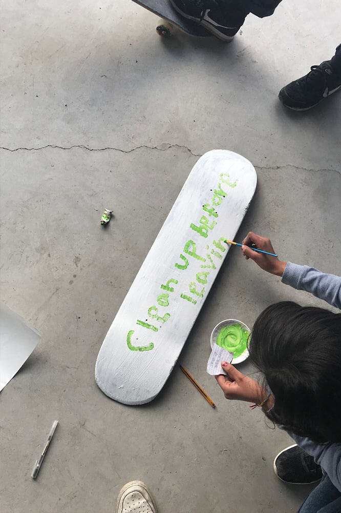 Girl painting a board in Athens, Greece