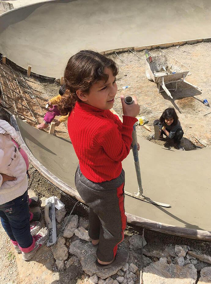 Girl building a skatepark in Syria