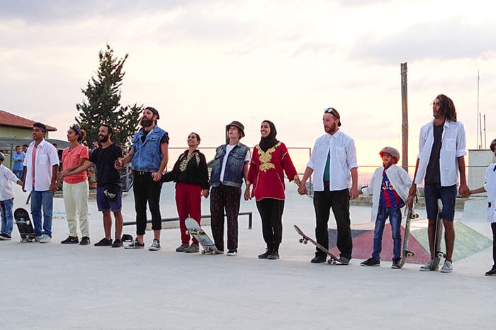 Group of skateboarders holding hands in Palestine