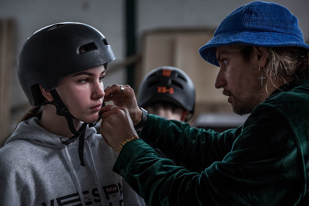  Yurii helps Karina, 14 from Odessa, to fasten her helmet.