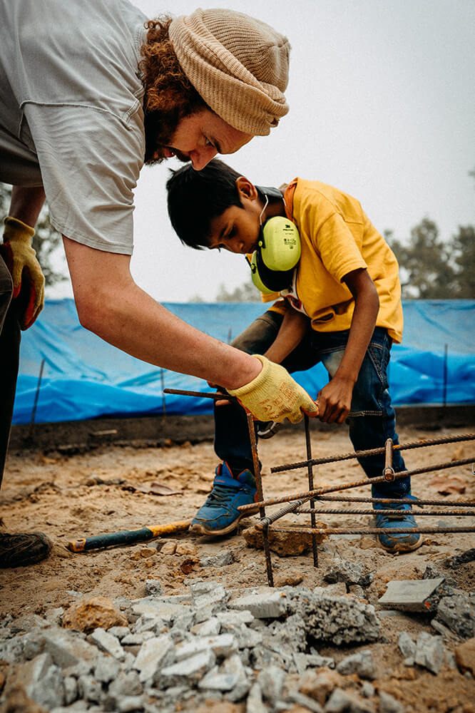 Skatepark builder teaching a local kids in Bangladesh